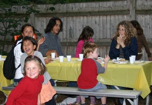 Children laugh and parents dine at annual bbq